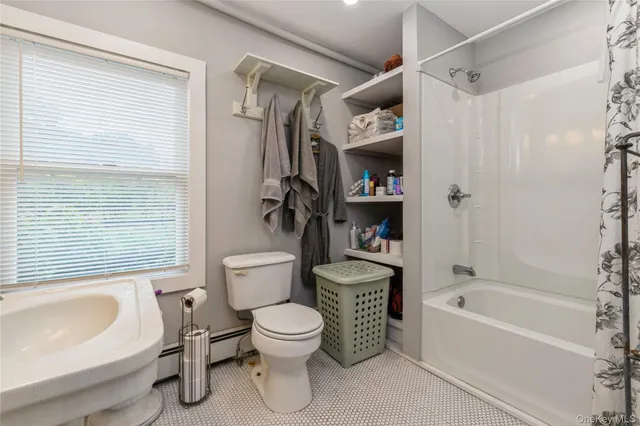 a bathroom with a toilet a sink and bathtub