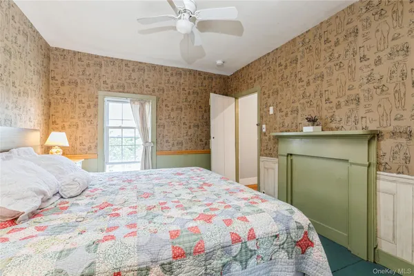 a bedroom with a bed and a window