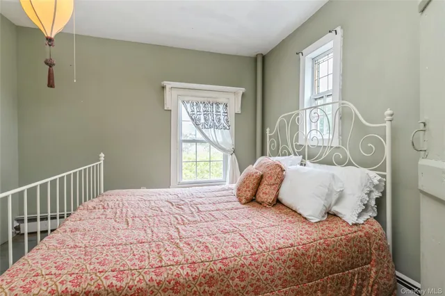 a bedroom with a large bed and a window