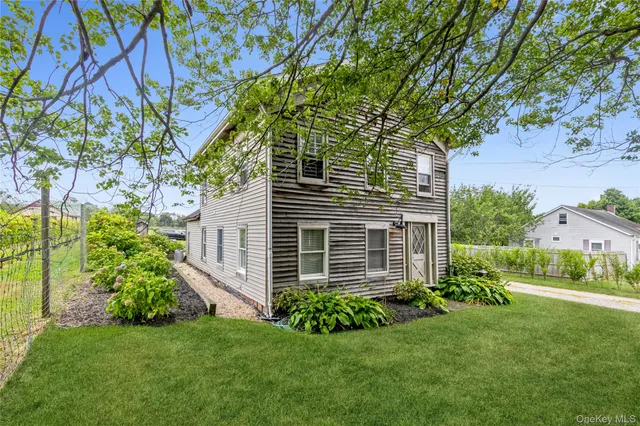 a view of a house with a yard and plants