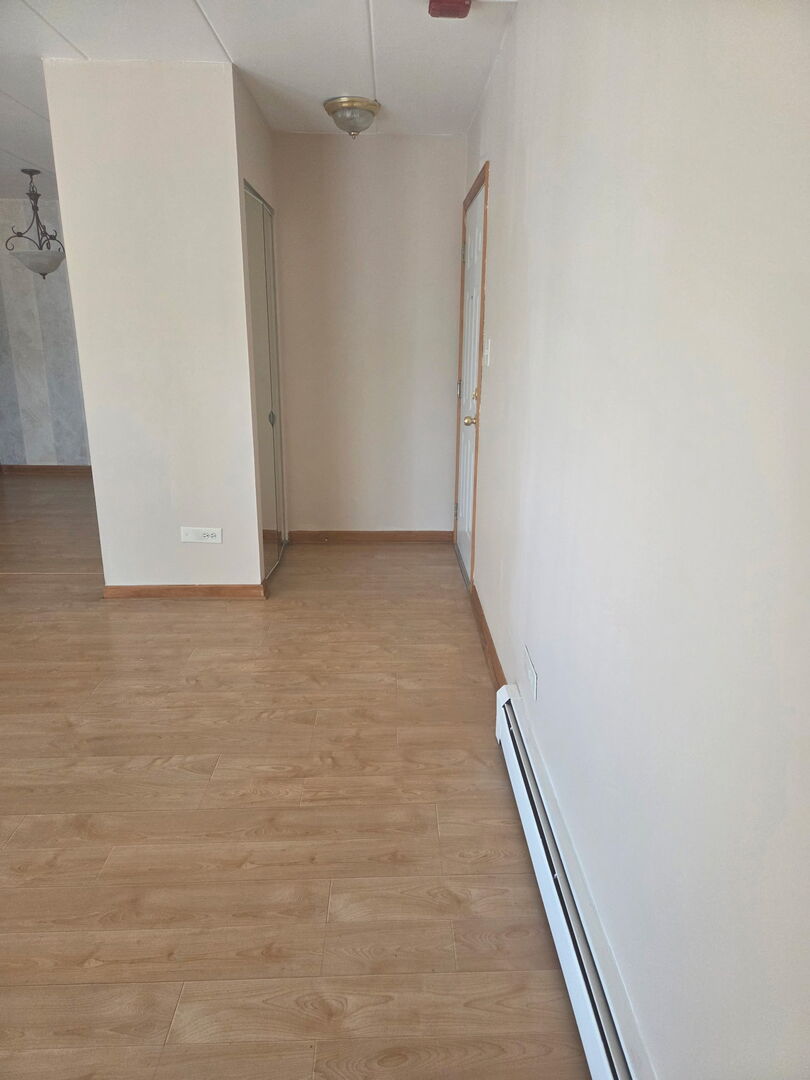 10510 Parkside Avenue, Unit 7 Chicago Ridge, IL 60415 - Photo 11 of 11 an empty room with wooden floor