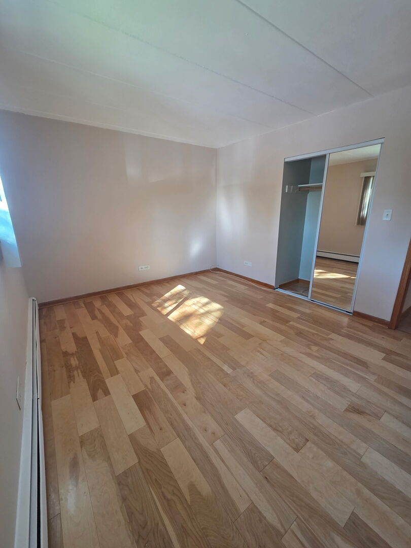 10510 Parkside Avenue, Unit 7 Chicago Ridge, IL 60415 - Photo 8 of 11 a view of an empty room and wooden floor