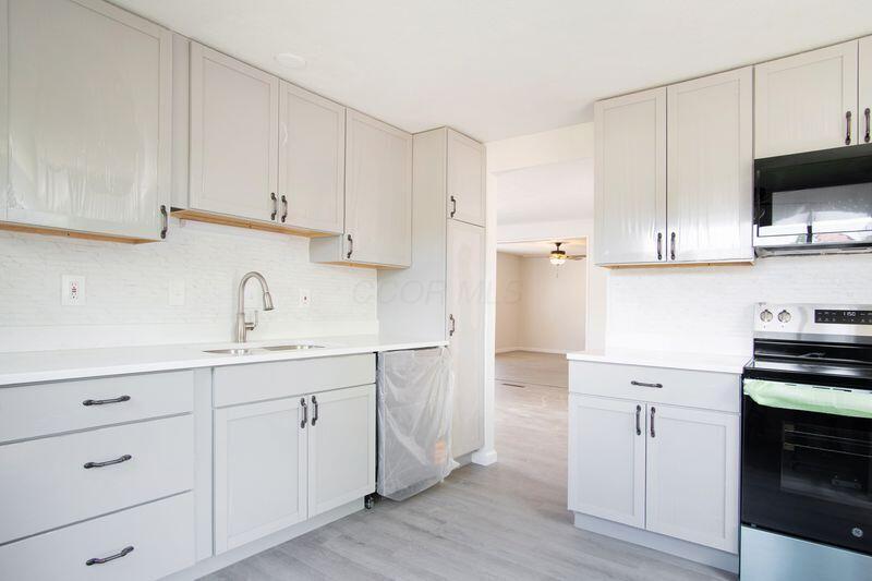 Updated Kitchen with NEW flooring, quartz countertops, cabinets, range/ove, microwave, dishwasher.