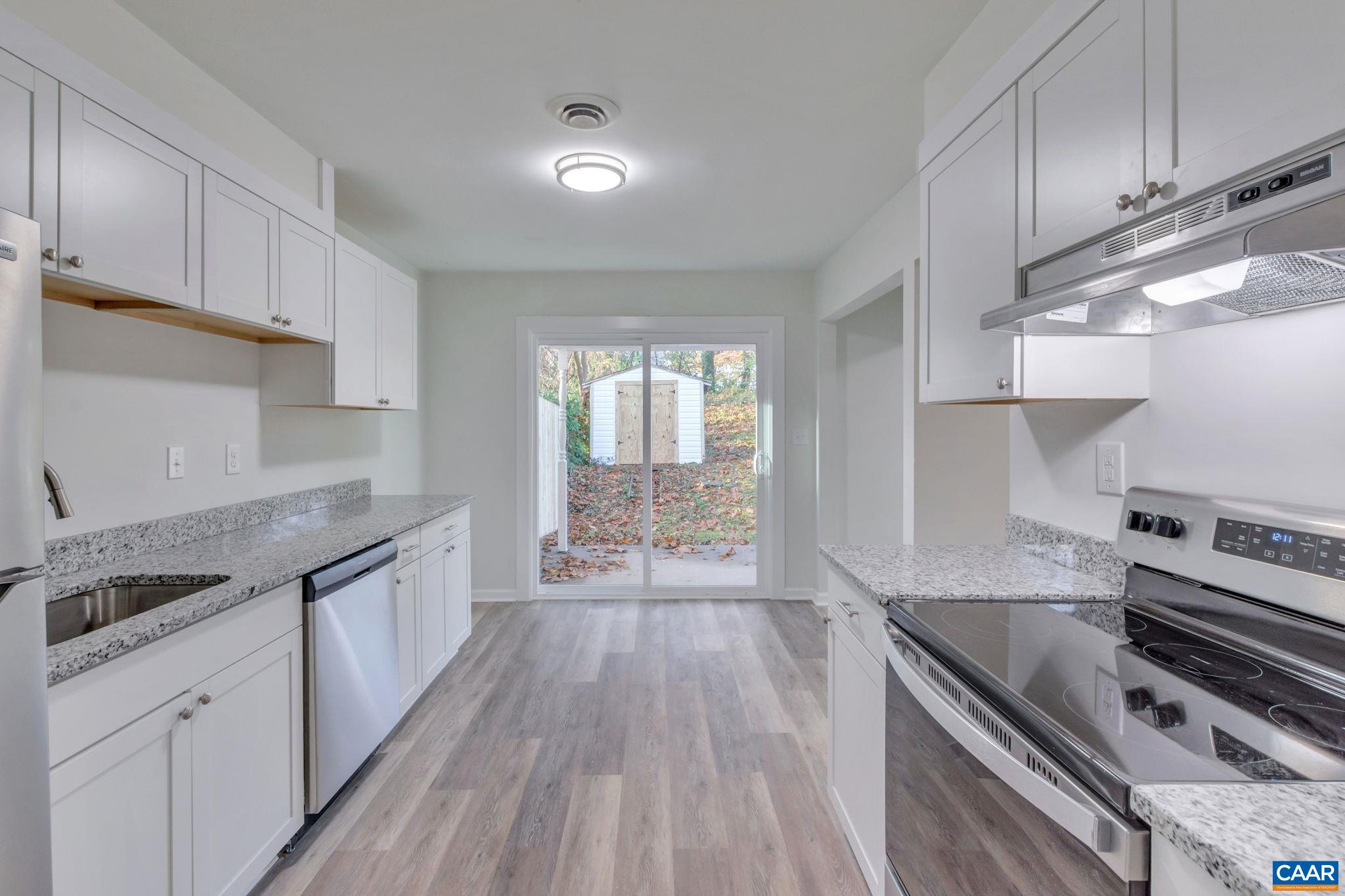 606 Bailey Road Charlottesville, VA 22903 - Photo 3 of 29 a kitchen with granite countertop a stove and a sink