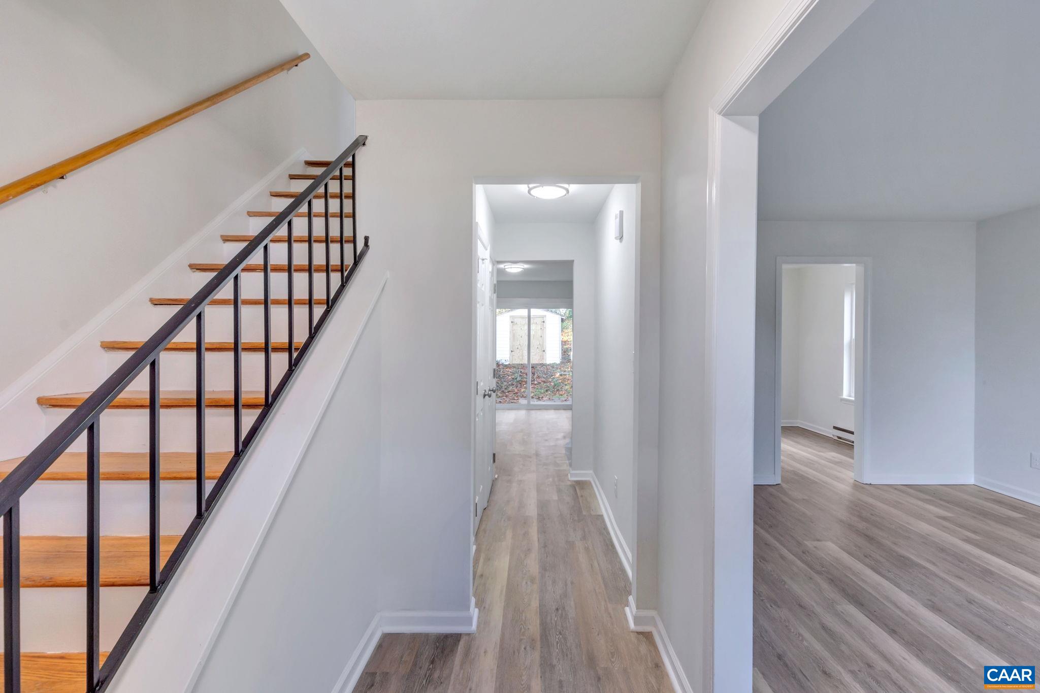 606 Bailey Road Charlottesville, VA 22903 - Photo 8 of 29 a view of a hallway with wooden floor and stairs