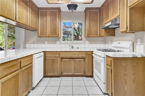 a kitchen with stainless steel appliances a sink stove and cabinets