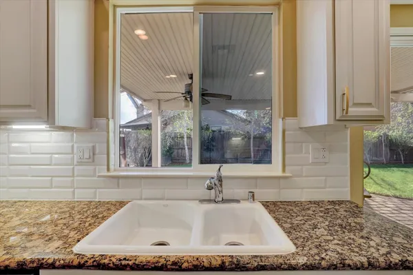a bathroom with a tub a double vanity sink and a large mirror