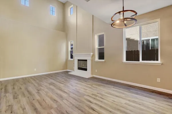 a kitchen with granite countertop white cabinets and a stove