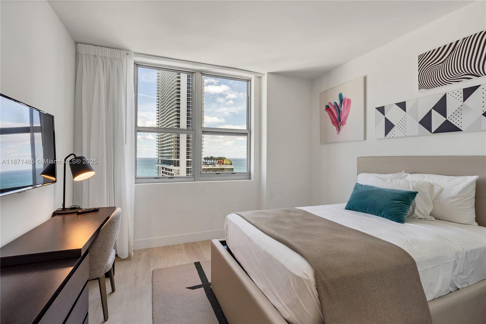 4010 South Ocean Drive, Unit R2301 Hollywood, FL 33019 - Photo 11 of 33 a bedroom with a bed and a window