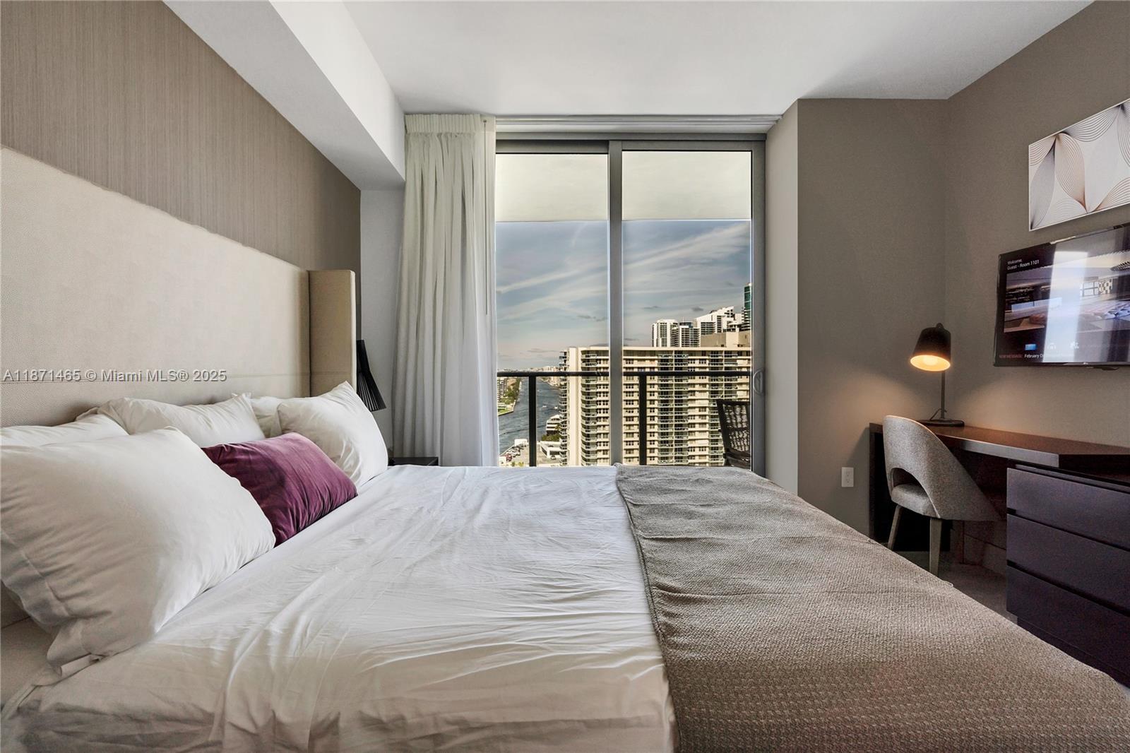 4010 South Ocean Drive, Unit R2301 Hollywood, FL 33019 - Photo 13 of 33 a bedroom with a large bed and a window