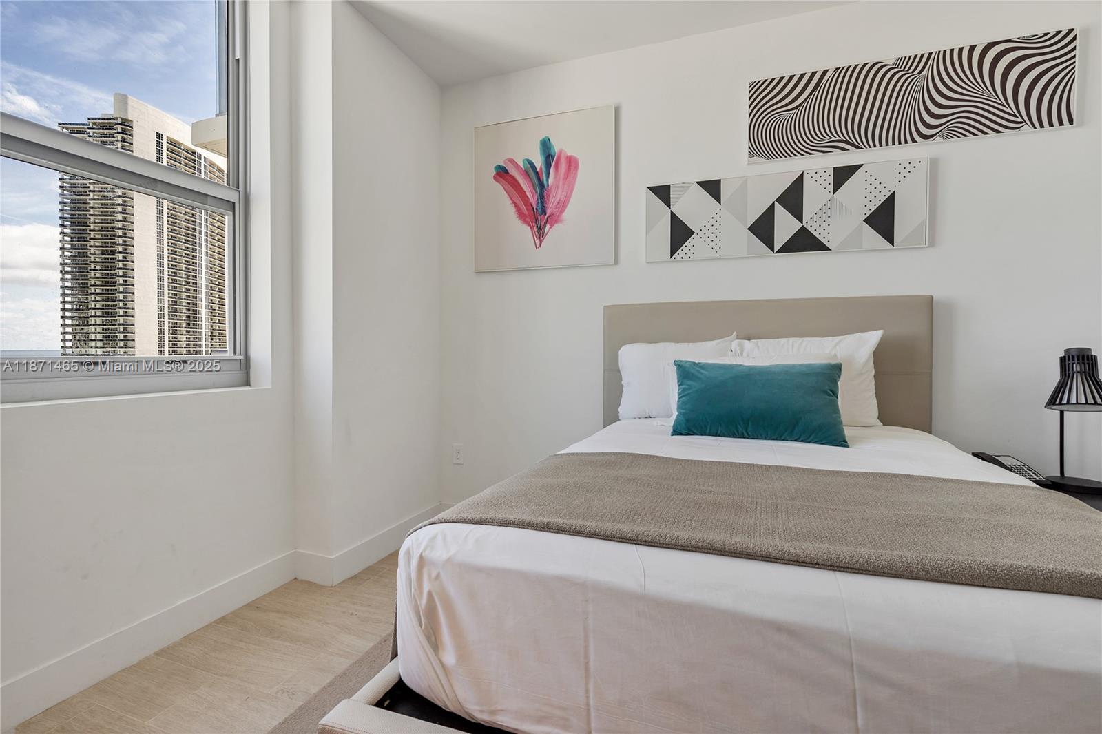 4010 South Ocean Drive, Unit R2301 Hollywood, FL 33019 - Photo 16 of 33 a bedroom with a bed and a window