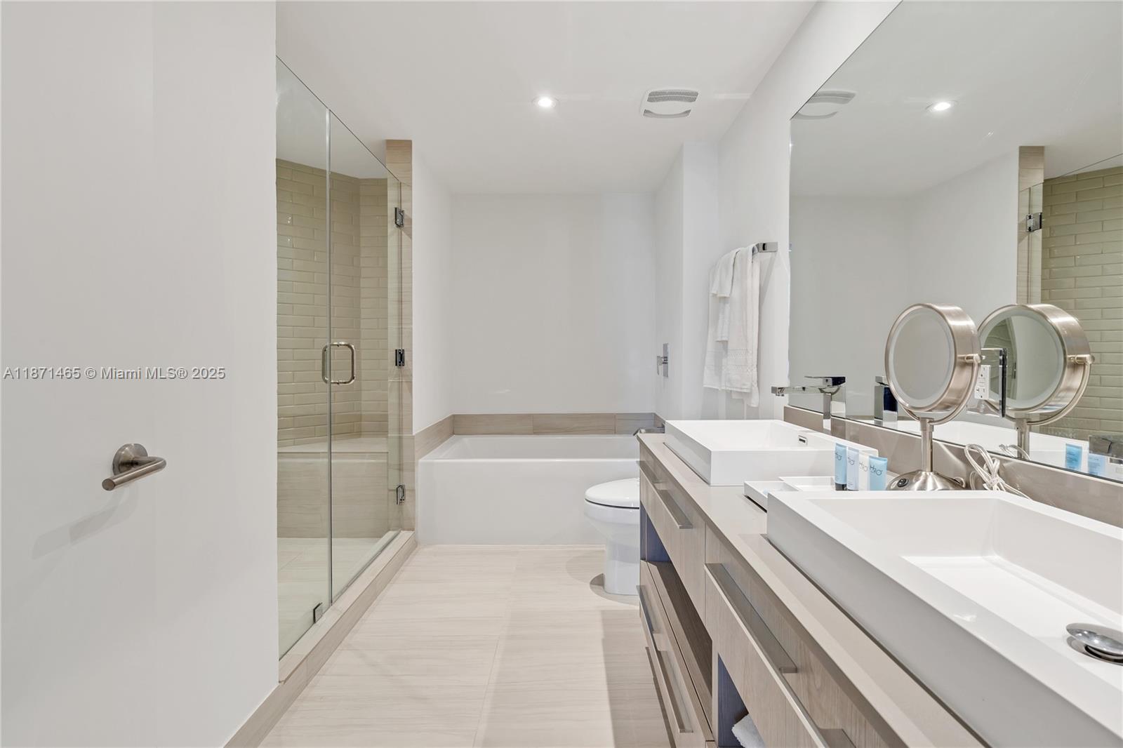 4010 South Ocean Drive, Unit R2301 Hollywood, FL 33019 - Photo 17 of 33 a bathroom with a double vanity sink a toilet and shower