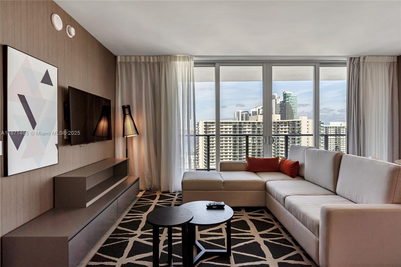 4010 South Ocean Drive, Unit R2301 Hollywood, FL 33019 - Photo 3 of 33 a living room with furniture and a flat screen tv