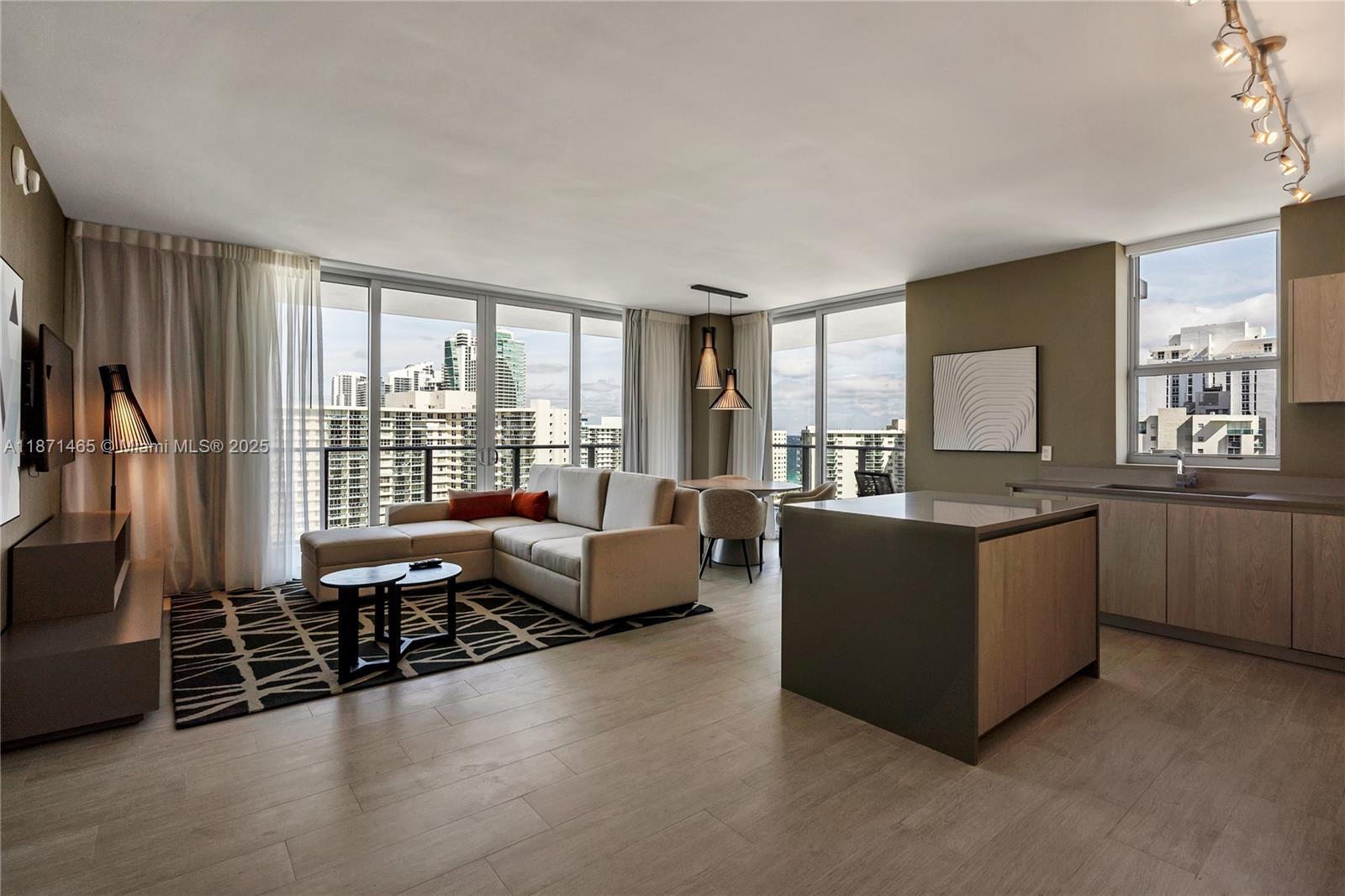 4010 South Ocean Drive, Unit R2301 Hollywood, FL 33019 - Photo 5 of 33 a living room with furniture and a flat screen tv