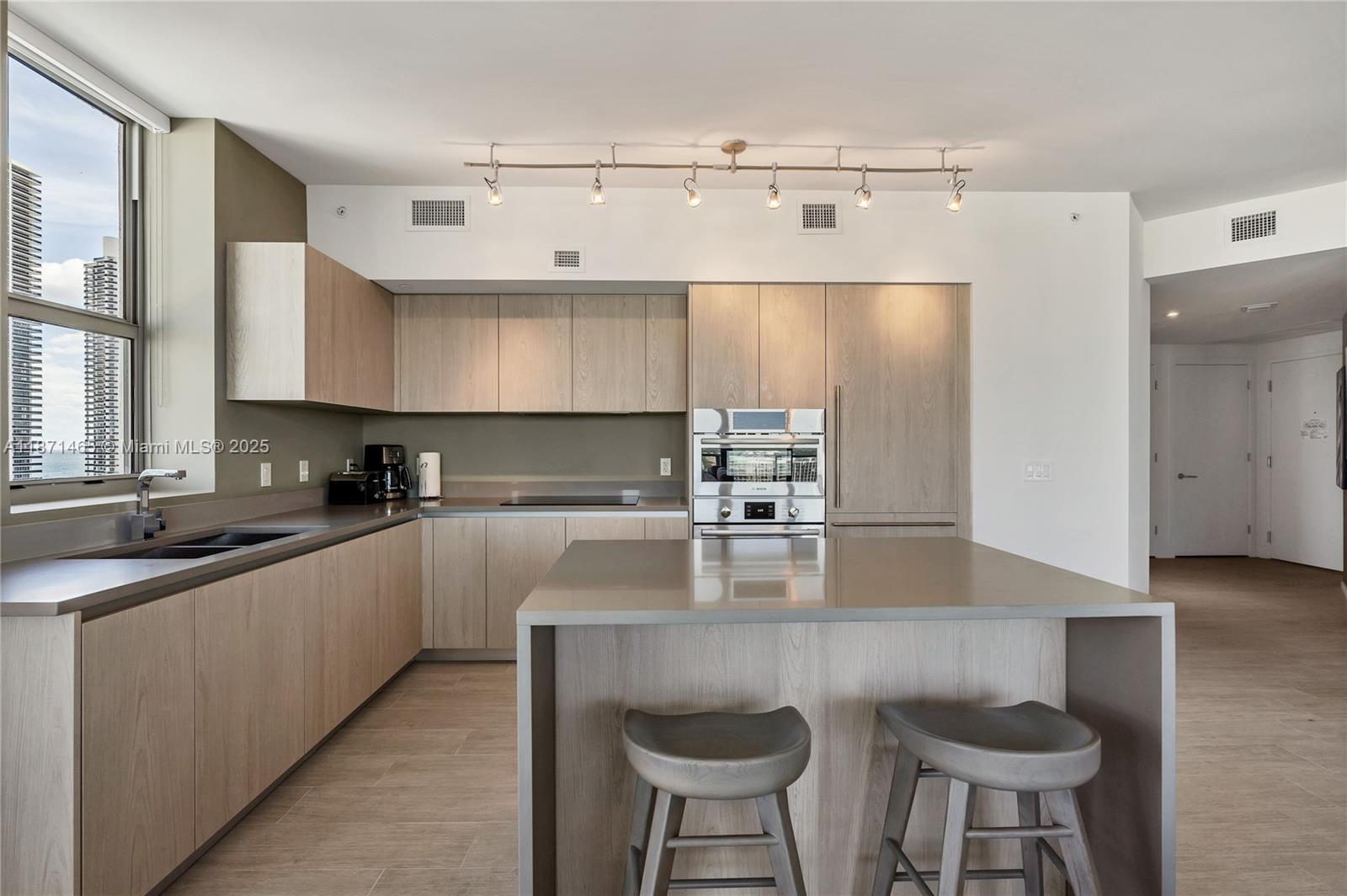 4010 South Ocean Drive, Unit R2301 Hollywood, FL 33019 - Photo 7 of 33 a kitchen with stainless steel appliances granite countertop a sink a stove a counter space and cabinets