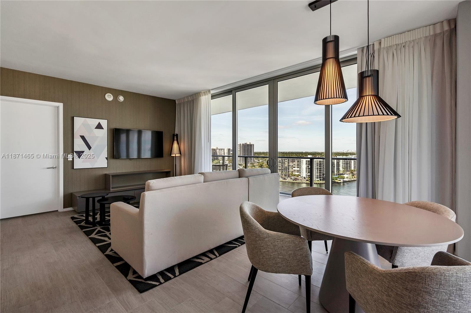 4010 South Ocean Drive, Unit R2301 Hollywood, FL 33019 - Photo 8 of 33 a dining room with furniture and a floor to ceiling window