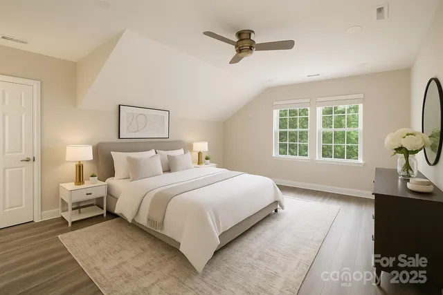 a bedroom with a bed a couch and a window