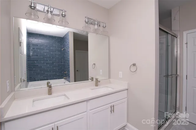 a bathroom with a shower and a sink