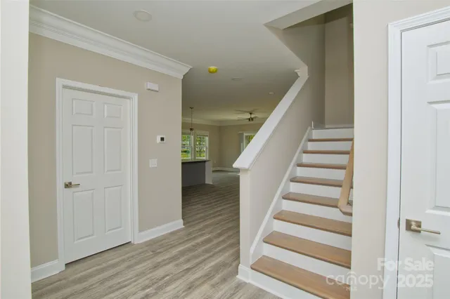 a living room with furniture kitchen view and a large window