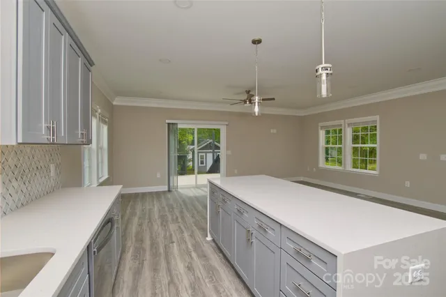 a kitchen with a sink a stove and cabinets