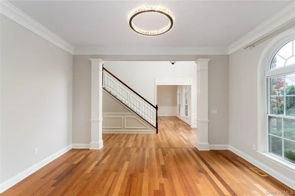 a view of a room with wooden floor staircase and windows