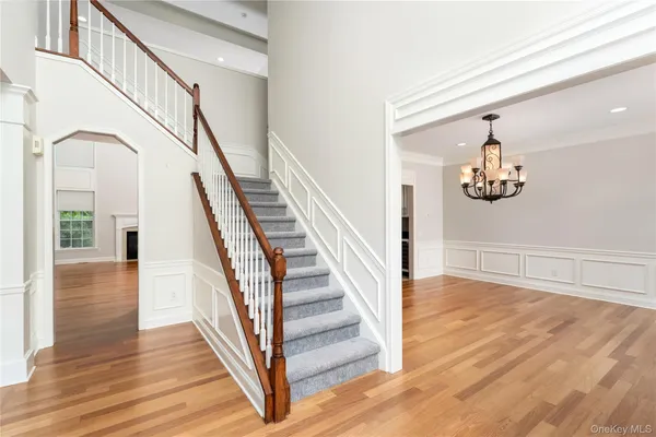 a view of staircase with wooden floor and a rug