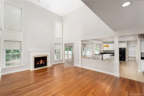 a view of a livingroom with wooden floor and a fireplace