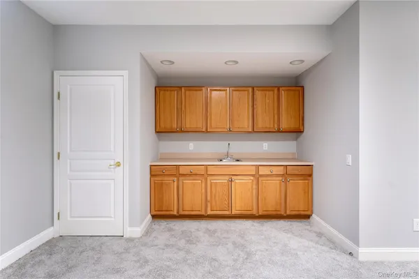 a kitchen with stainless steel appliances granite countertop a sink and a white cabinets