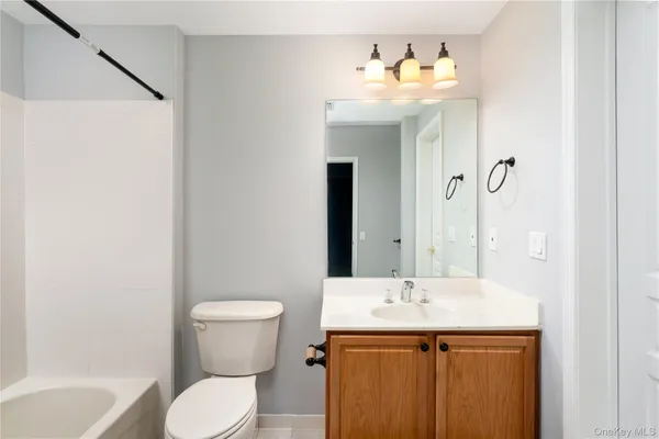 a view of entryway with kitchen and wooden floor
