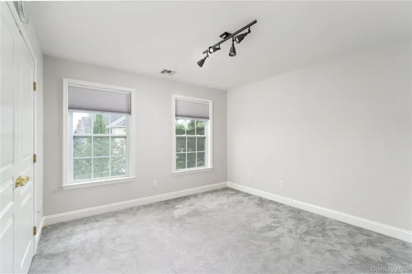 a view of an empty room with a ceiling fan