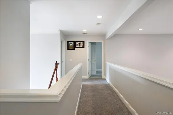 a view of an empty room with a fireplace and a window