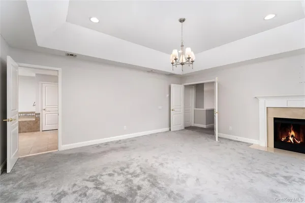 a view of an empty room with a fireplace and a window