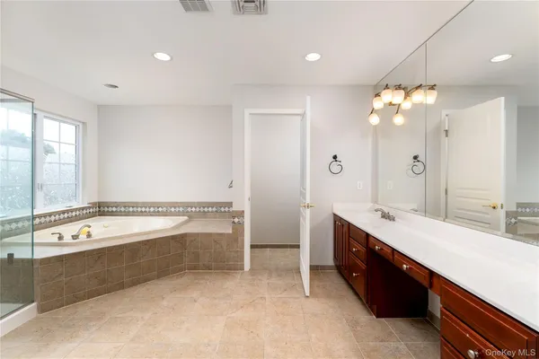 a view of bathroom with bathtub and shower