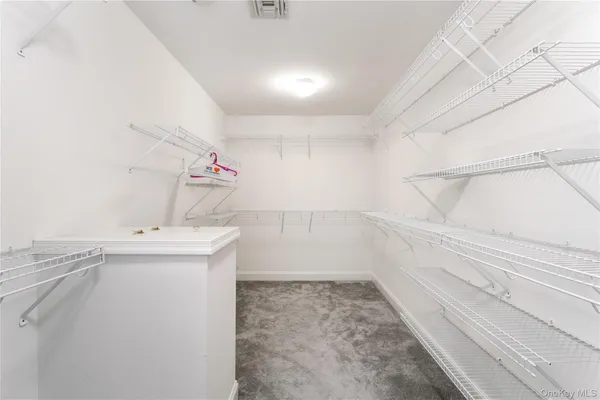 an empty room with windows and cabinet