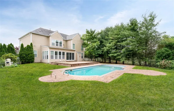 a view of pool with a yard