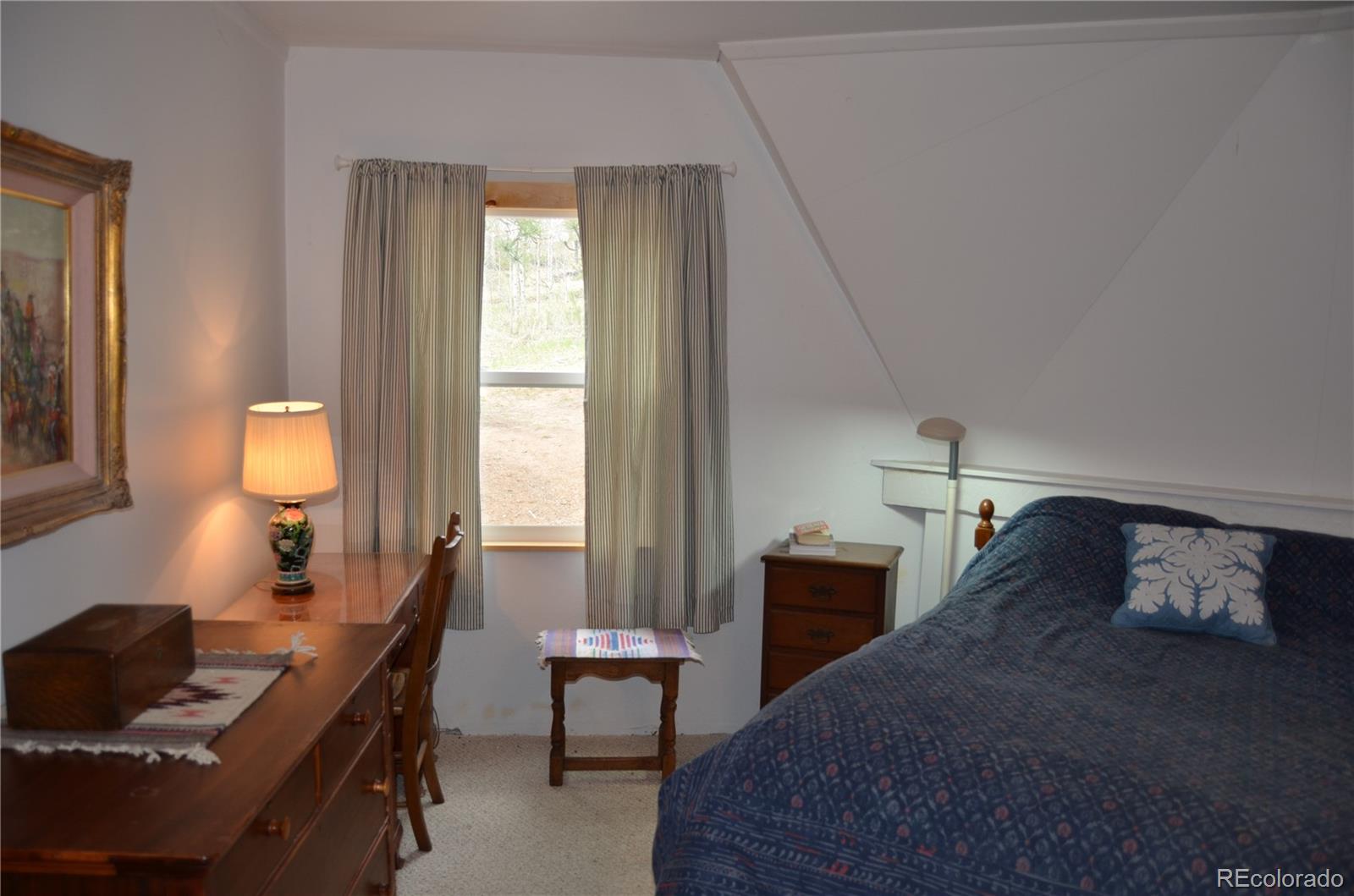 195 Baker Road Bailey, CO 80421 - Photo 18 of 24 a bedroom with a bed and a window