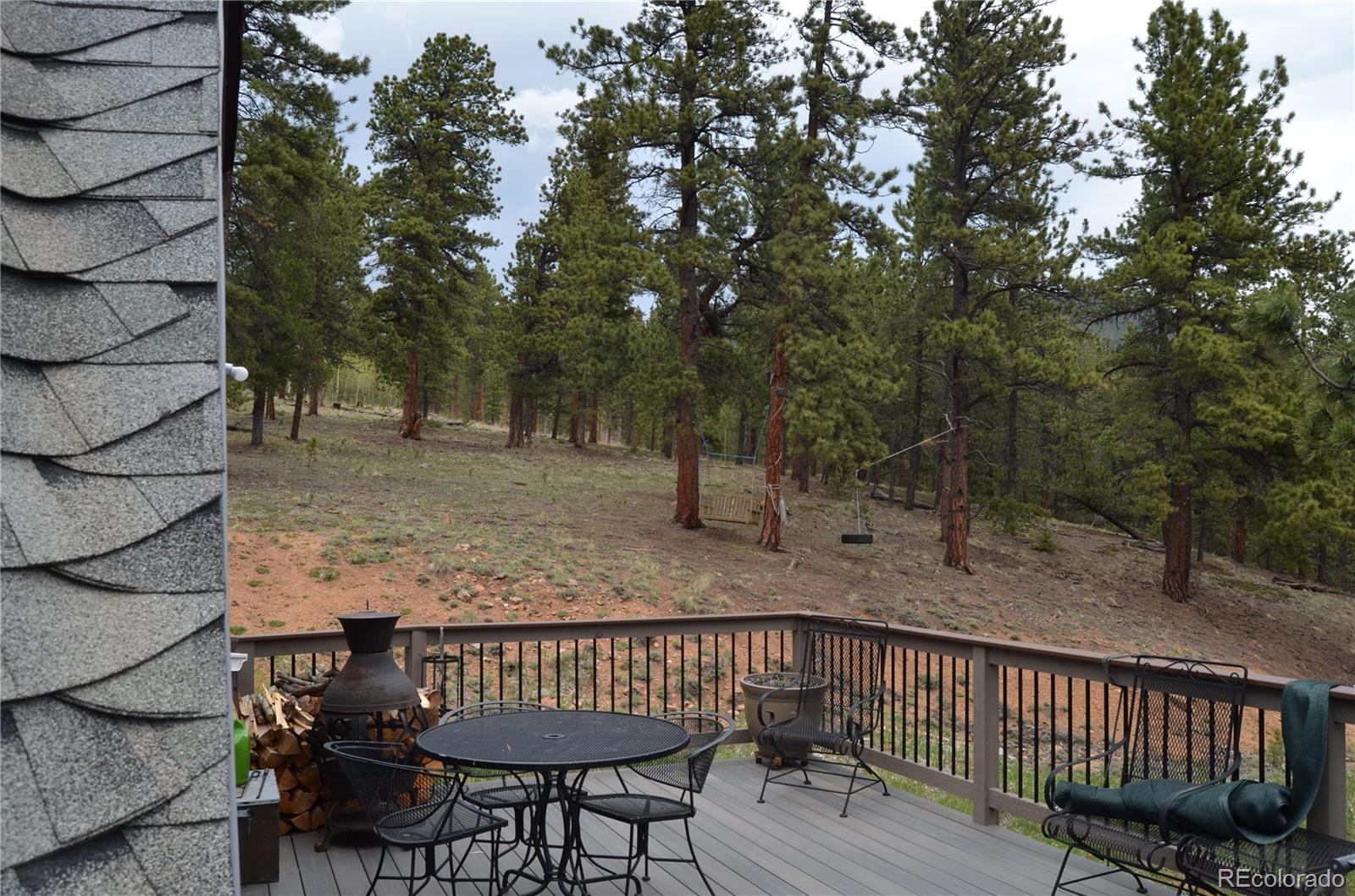 195 Baker Road Bailey, CO 80421 - Photo 4 of 24 a view of a roof deck with wooden fence and trees