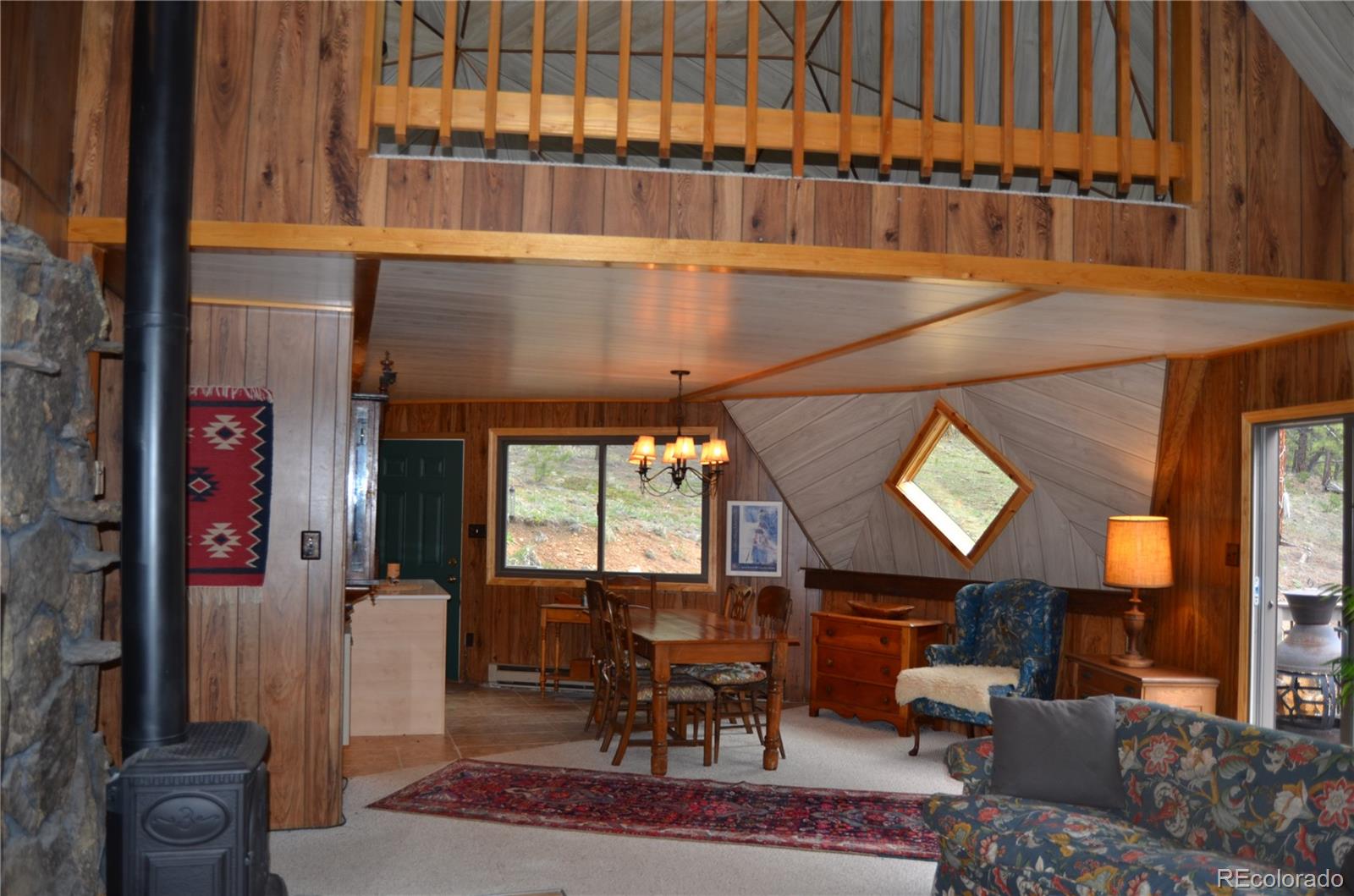 195 Baker Road Bailey, CO 80421 - Photo 7 of 24 a living room with furniture a window and a fireplace