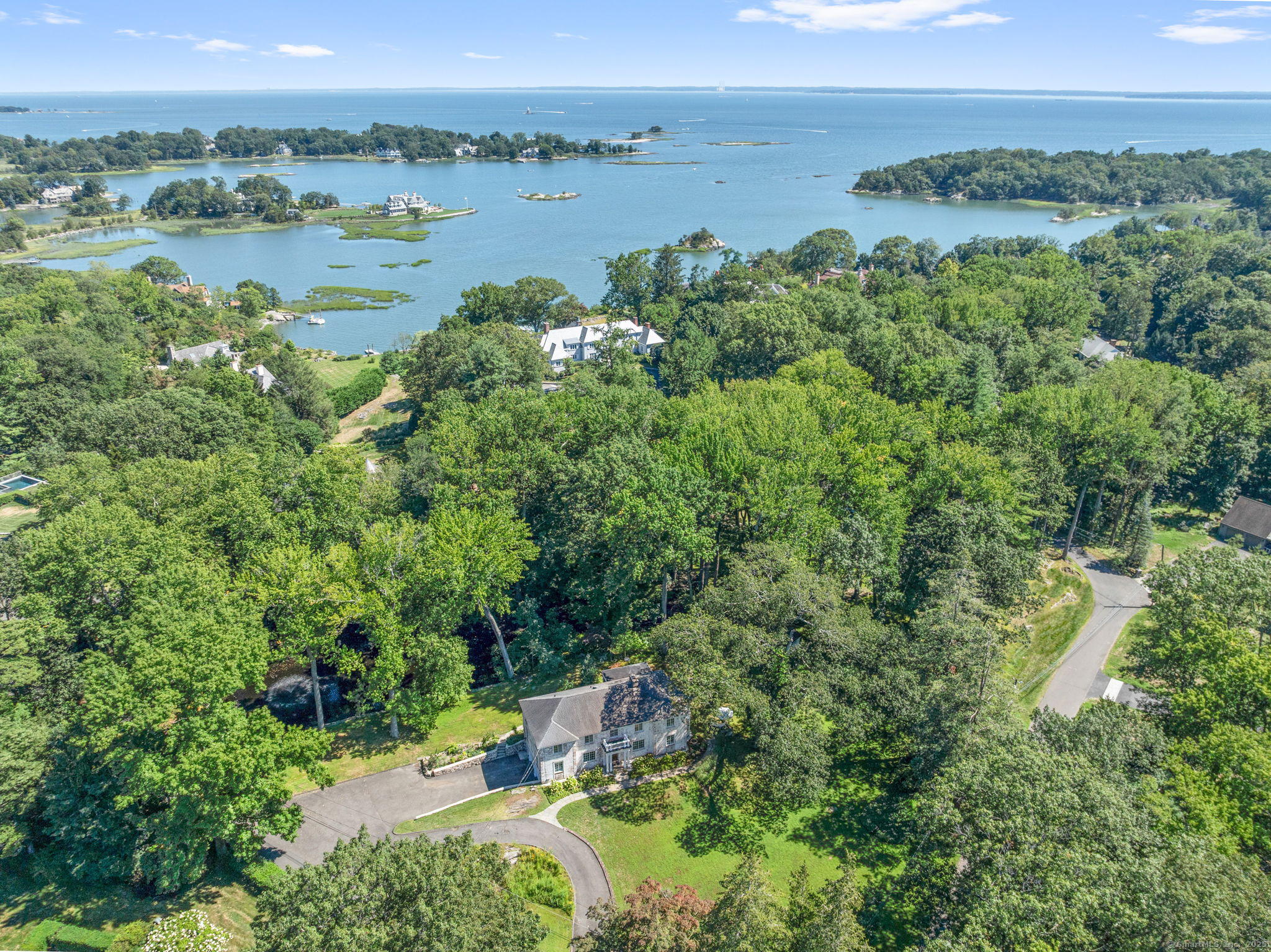 46 Sunswyck Road Darien, CT 06820 - Photo 1 of 1 an aerial view of green landscape with trees houses and lake view