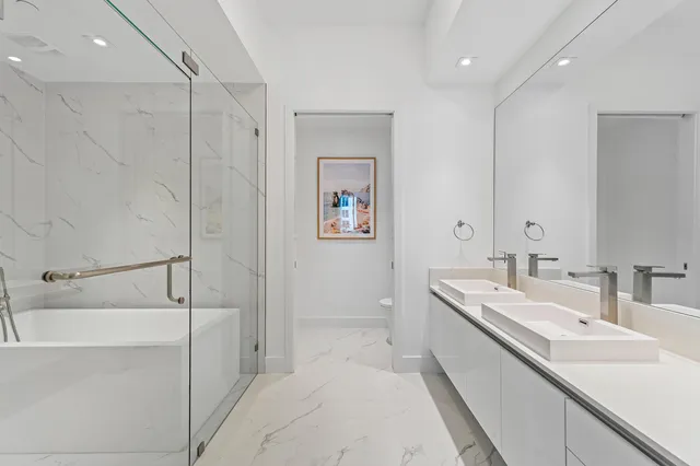 a bedroom with a bed and a large mirror with wooden floor