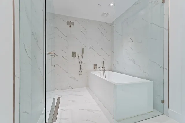 a bedroom with two beds and a large mirror