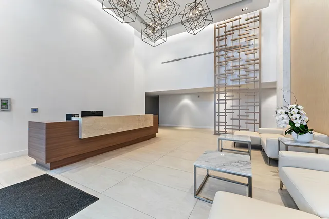 a dining room with furniture and a large window