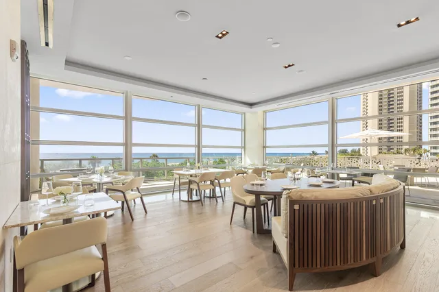 a living room with a table and chairs