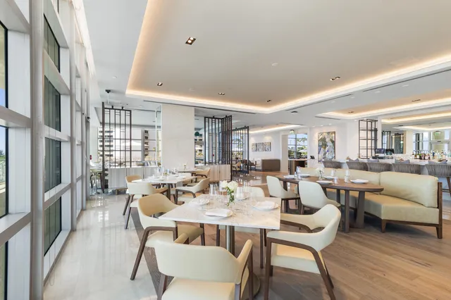 a dining room with furniture and a window