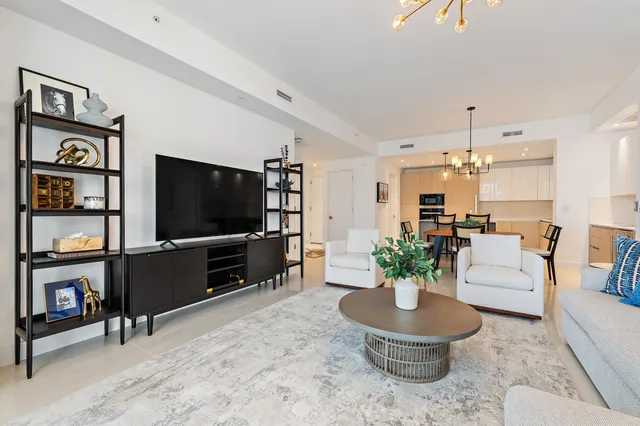 a spacious bedroom with a bed and a flat screen tv