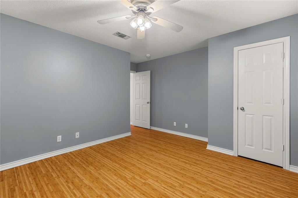 2917 Harlow Road Commerce, TX 75428 - Photo 23 of 40 a view of an empty room with wooden floor