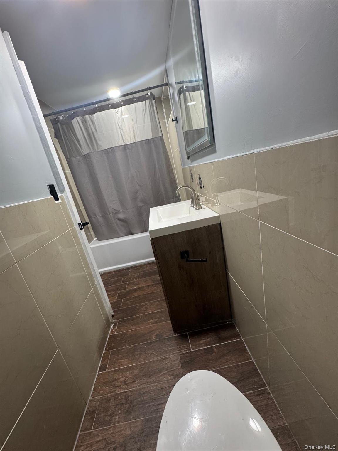 116-23 Inwood Street Queens, NY 11436 - Photo 12 of 22 a bathroom with a sink and mirror