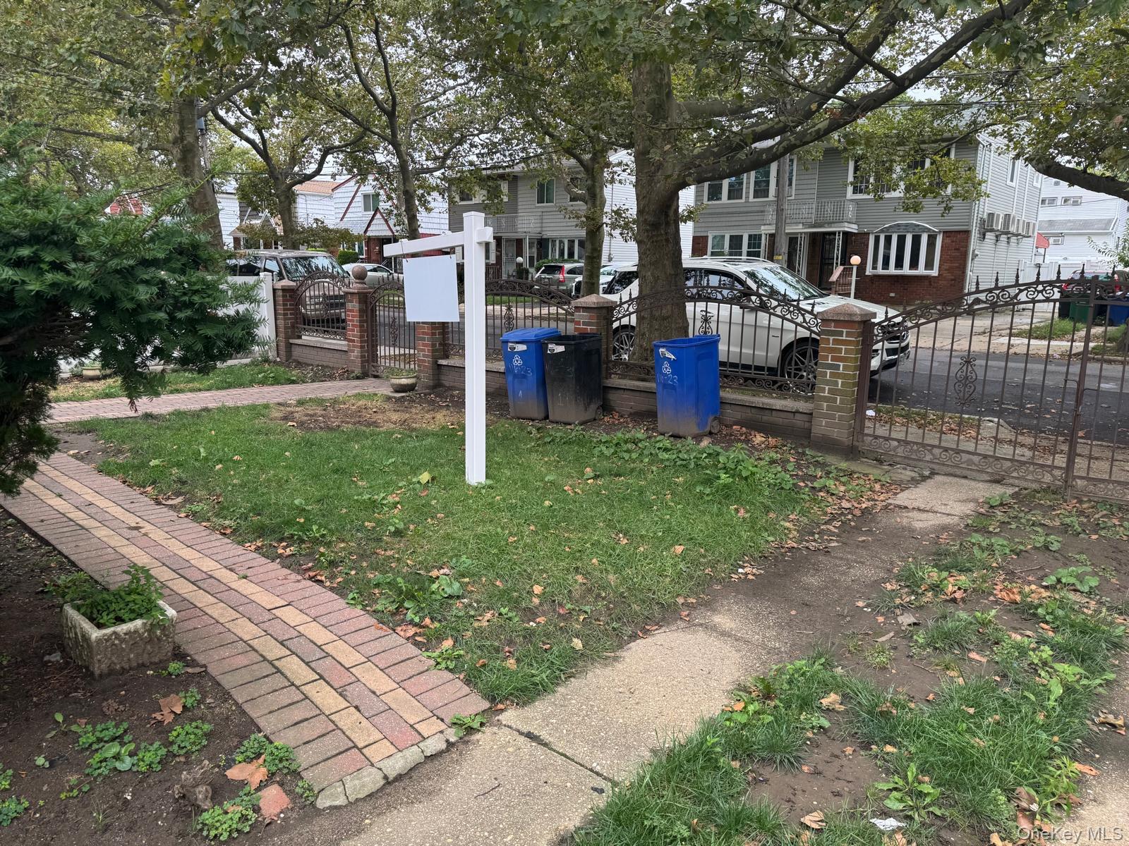 116-23 Inwood Street Queens, NY 11436 - Photo 15 of 22 a view of a house with a yard patio and fire pit