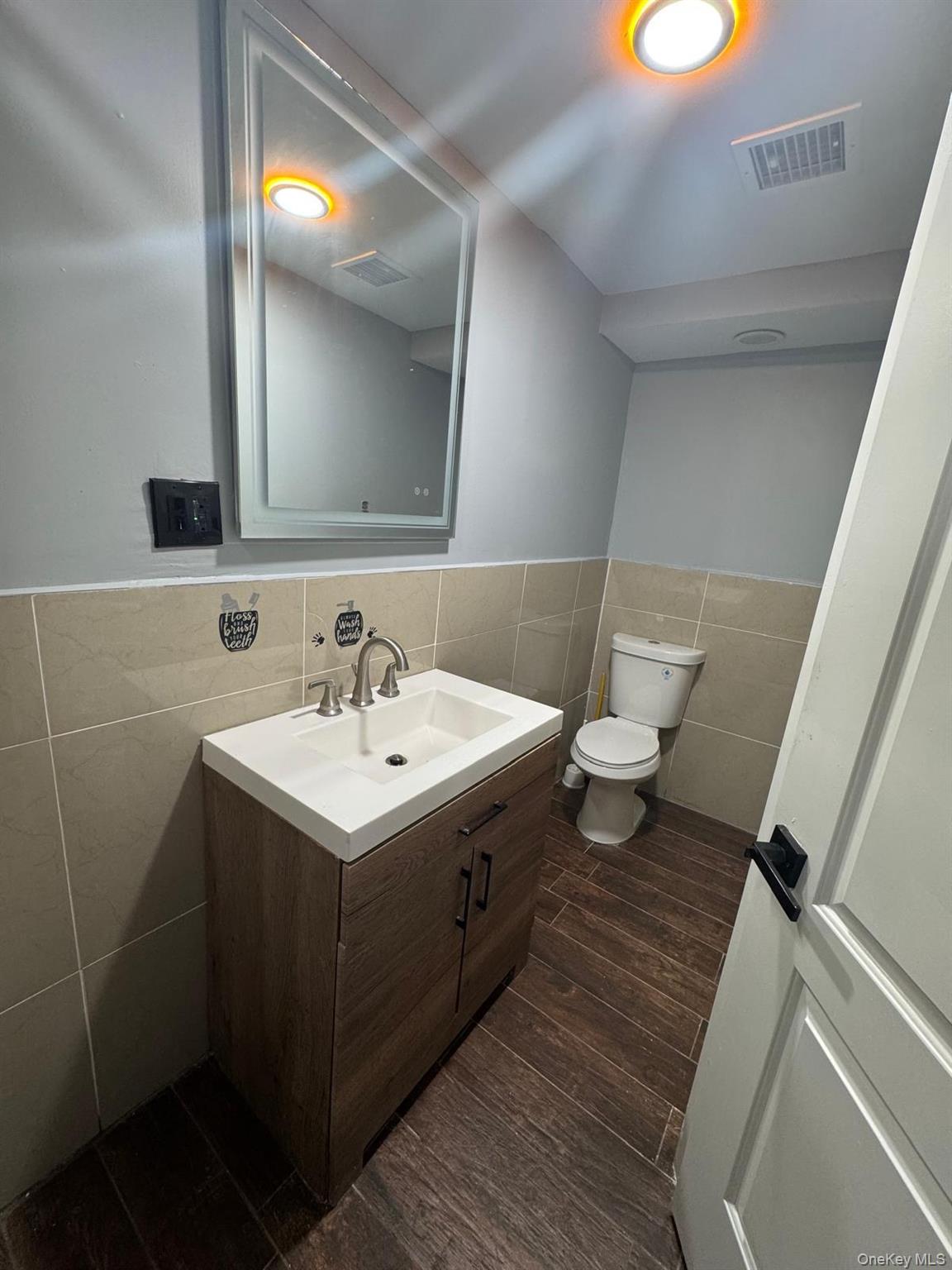 116-23 Inwood Street Queens, NY 11436 - Photo 17 of 22 a bathroom with a sink toilet and mirror