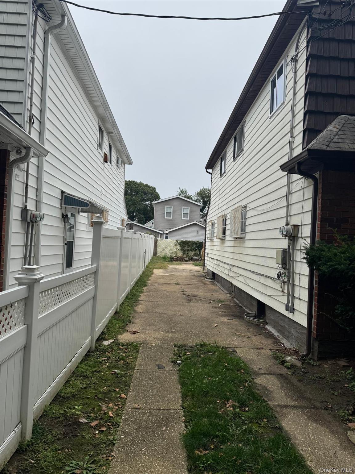 116-23 Inwood Street Queens, NY 11436 - Photo 8 of 22 a view of a back yard of the house